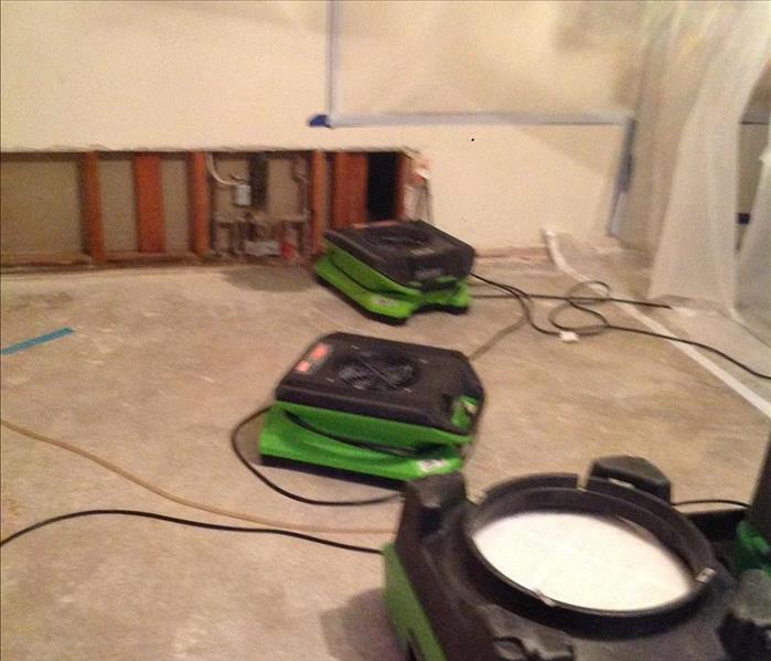green air blowers on cement drying the floors 