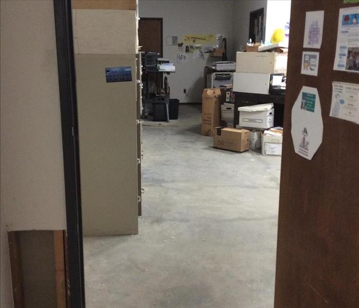 gray floors with boxes stacked up in the back 