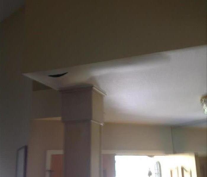a picture of a ceiling with swelling due to water white walls 